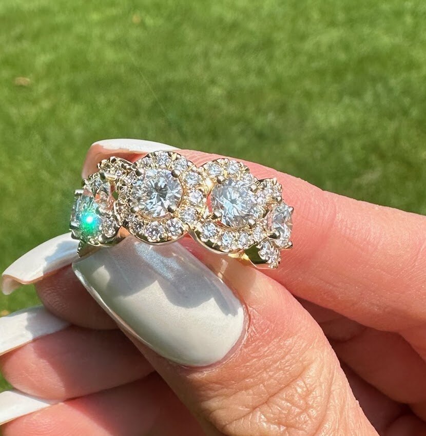 Colorful custom ring held in hand outdoors